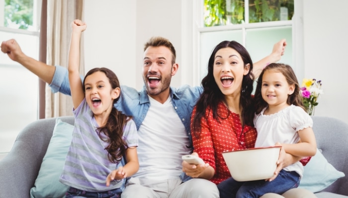 Bigstock Happy Family Cheering While Wa 136906679